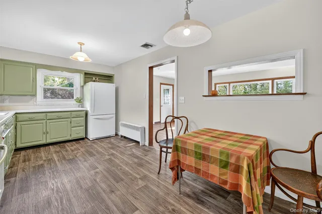 a kitchen with cabinets appliances a sink and a counter space