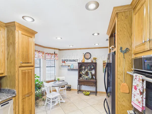 a kitchen with stainless steel appliances granite countertop a sink and a stove