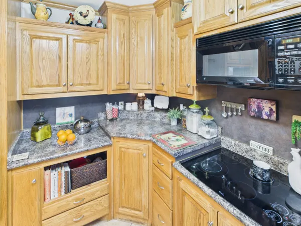 a kitchen with stainless steel appliances granite countertop a refrigerator a stove top oven a sink and dishwasher