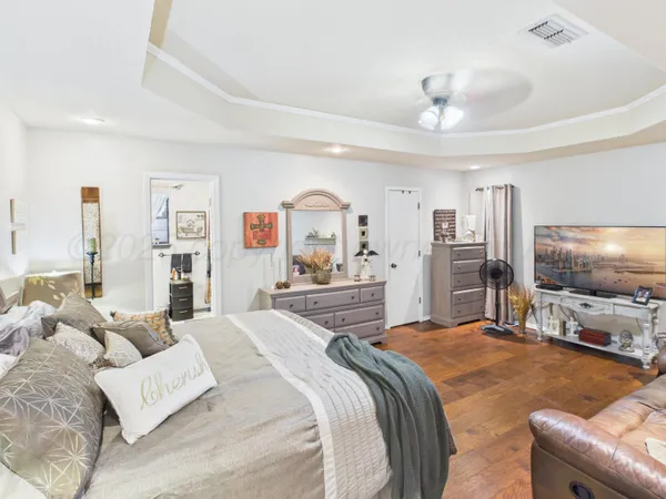 a hallway with furniture and wooden floor