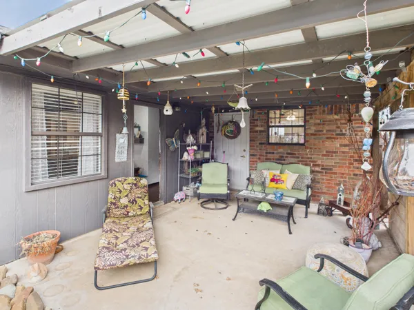 a view of a house with porch and wooden fence