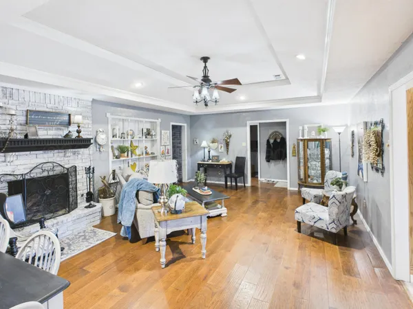 a living room with furniture and wooden floor