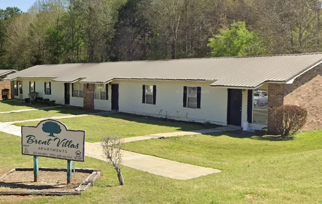a view of an house with backyard and trees