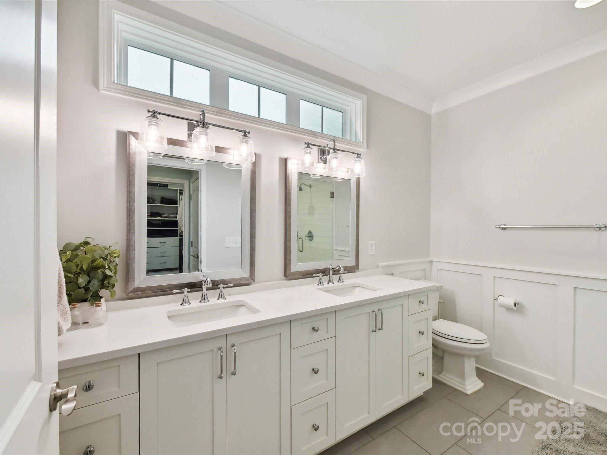335 Greystone Road Charlotte, NC 28209 - Photo 19 of 37 a bathroom with a double vanity sink and a mirror