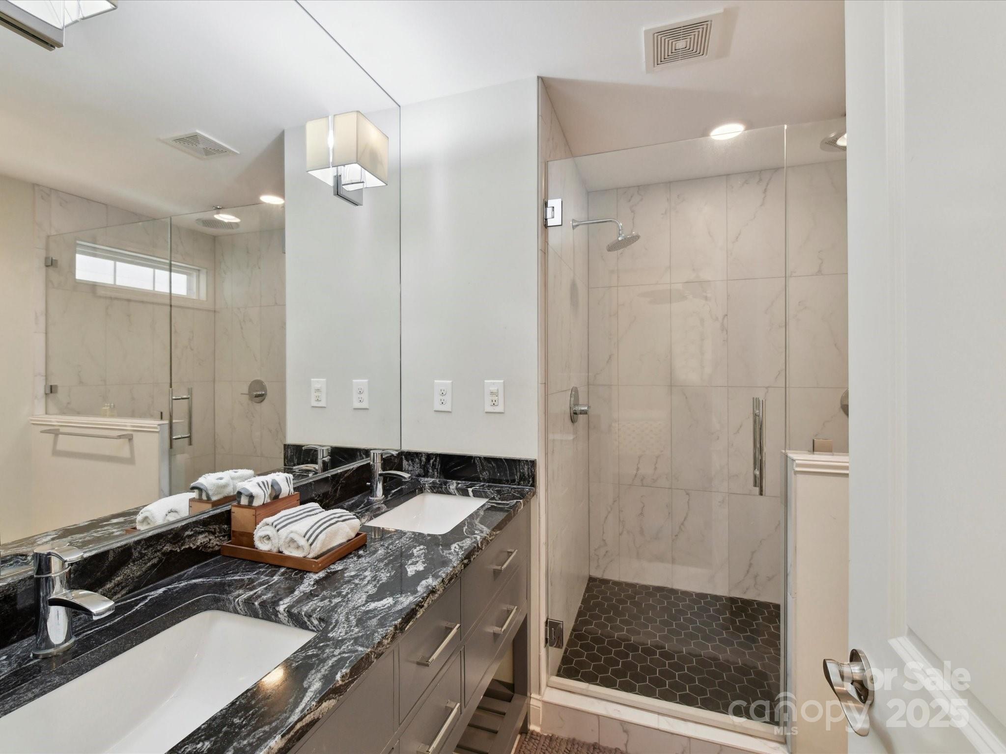 335 Greystone Road Charlotte, NC 28209 - Photo 25 of 37 a bathroom with a sink double vanity and a mirror