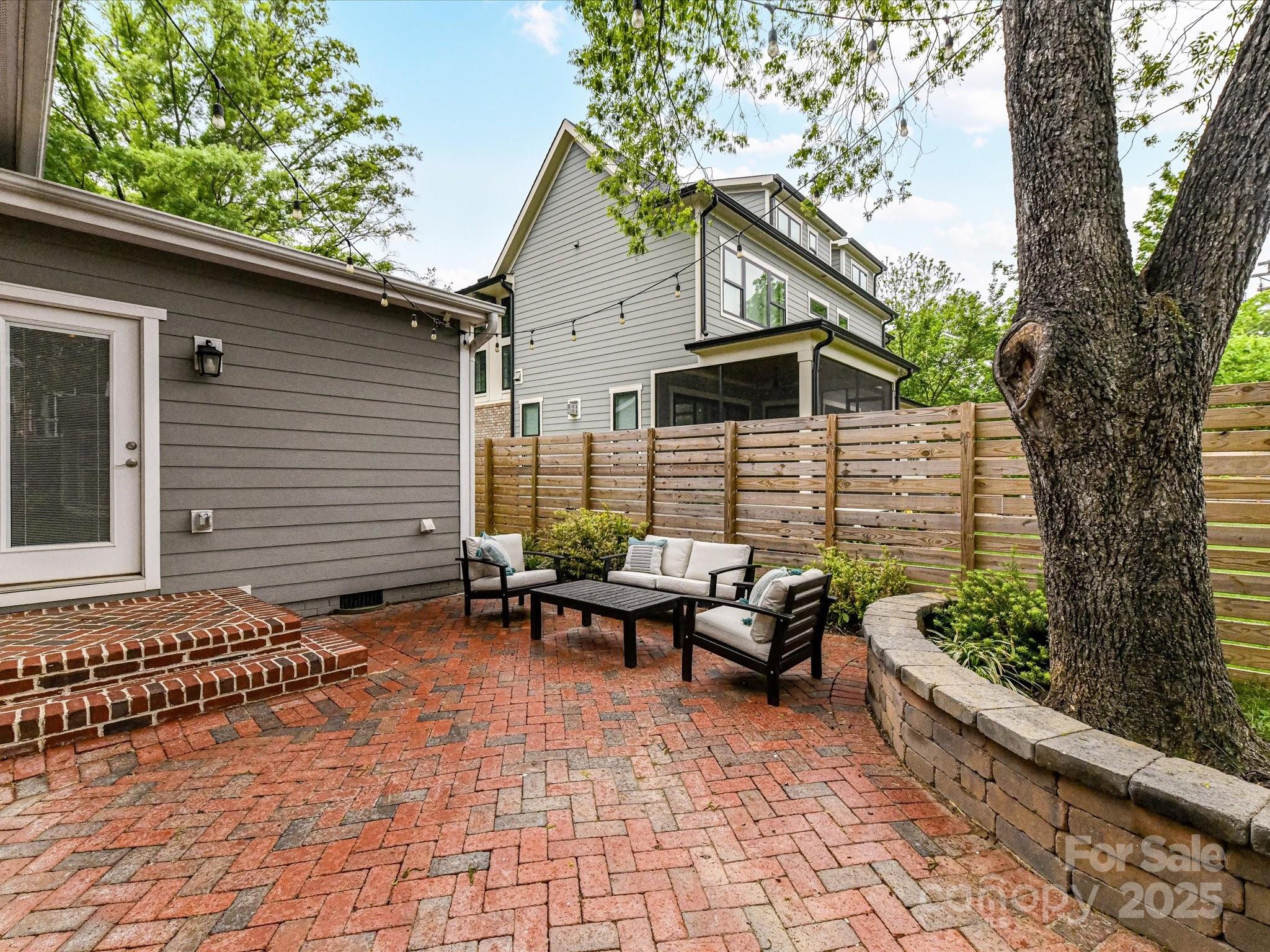 335 Greystone Road Charlotte, NC 28209 - Photo 34 of 37 a view of a chairs and tables in the back yard of the house