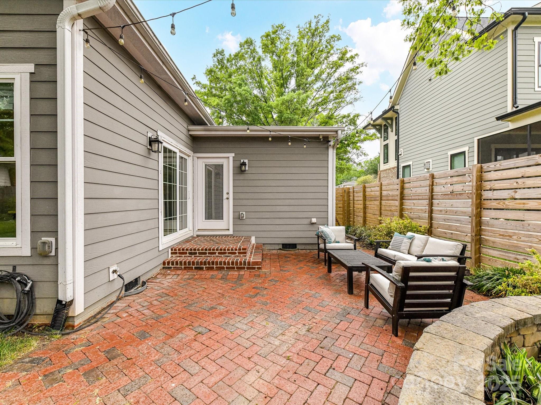 335 Greystone Road Charlotte, NC 28209 - Photo 35 of 37 a view of a patio with a table and chairs