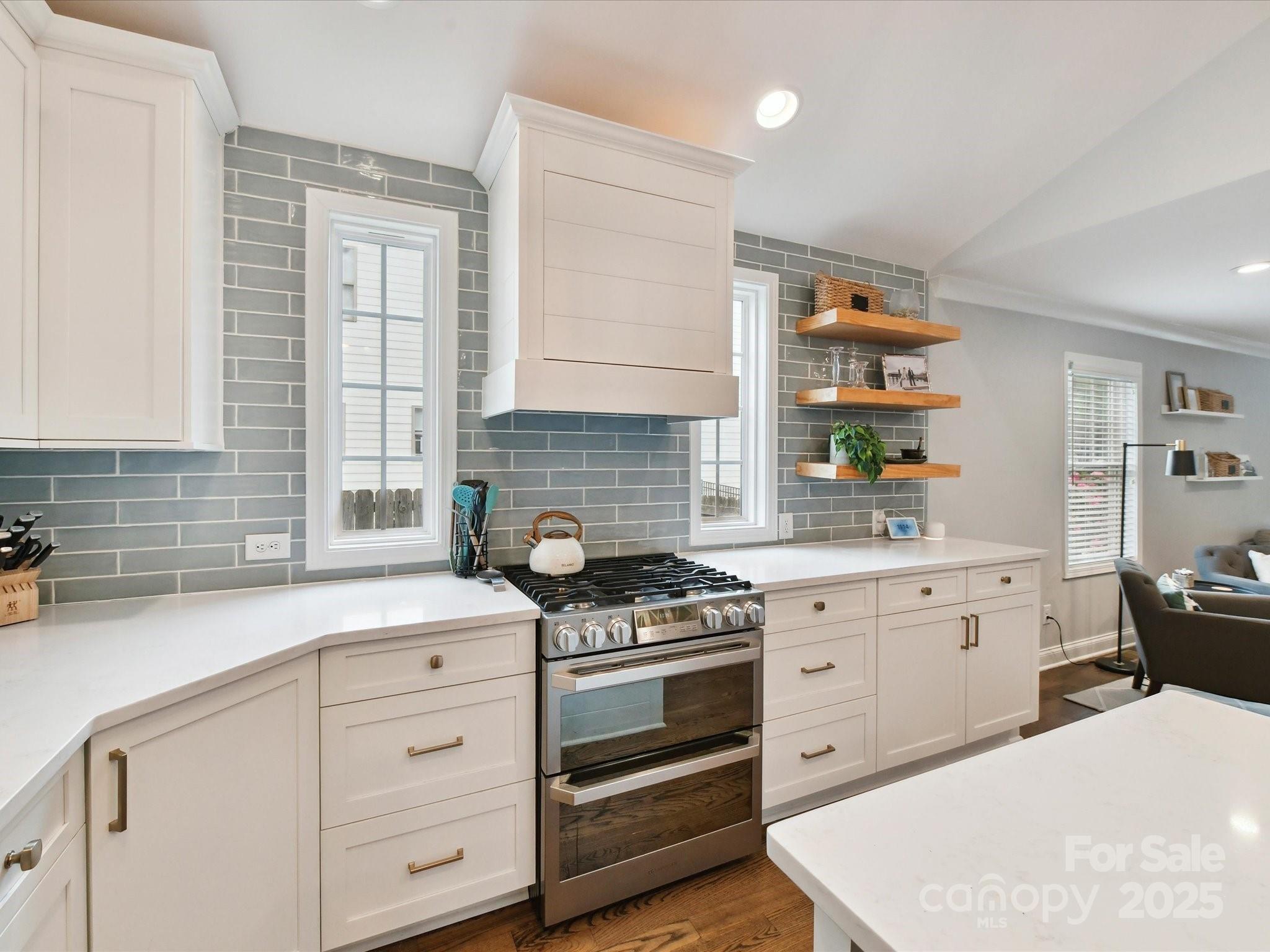 335 Greystone Road Charlotte, NC 28209 - Photo 7 of 37 a kitchen with white cabinets and appliances