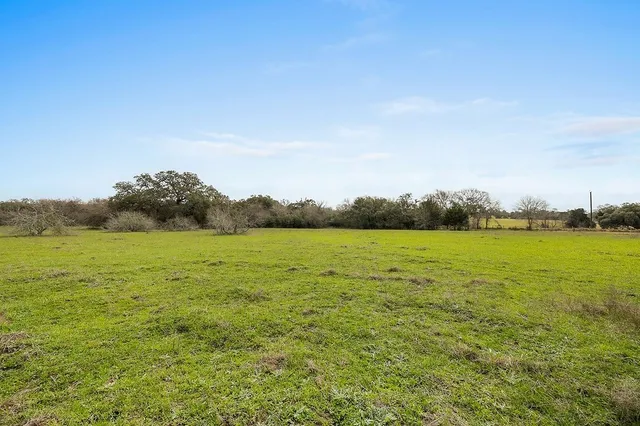a view of a lake with houses in the back