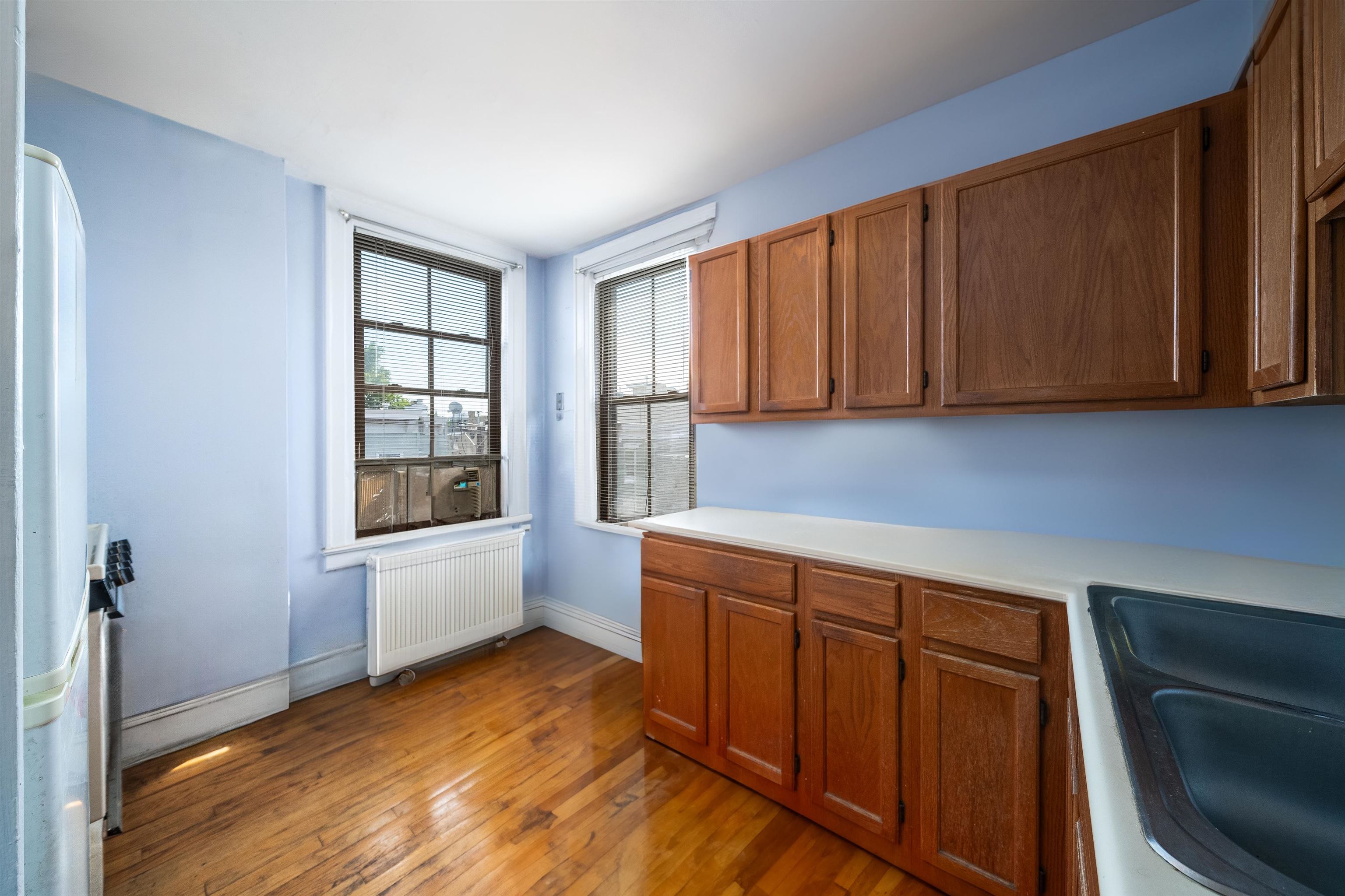 800 Bloomfield Street Hoboken, NJ 07030 - Photo 21 of 38 a kitchen with wooden cabinets and a window