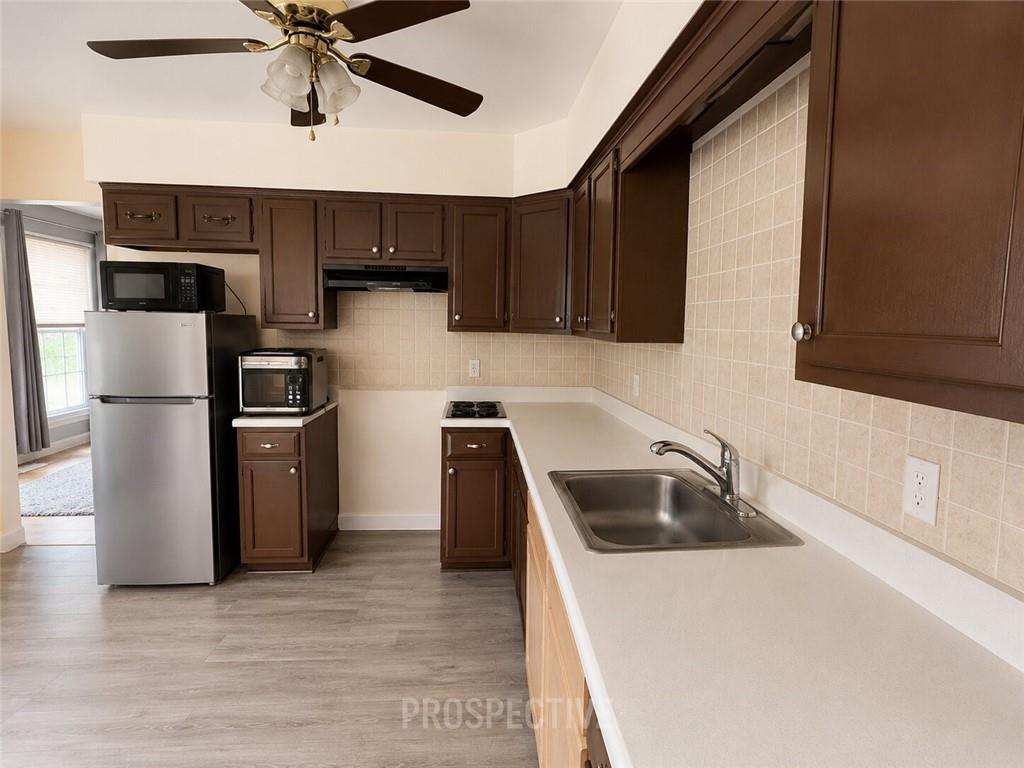 215 Maple Street Kittanning, PA 16201 - Photo 12 of 39 a kitchen with a sink and a refrigerator