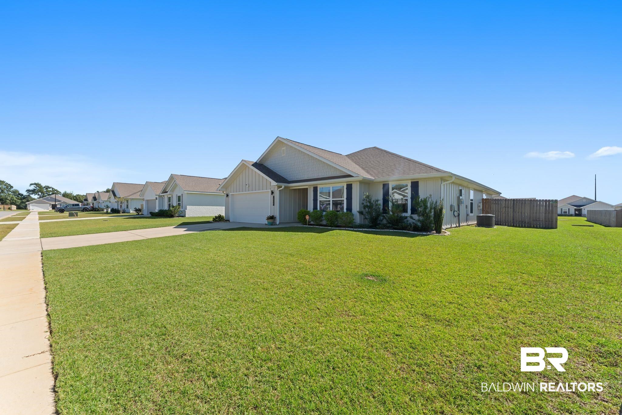 24337 Ringneck Loop Elberta, AL 36530 - Photo 2 of 34 View of front of house featuring board and batten siding, driveway, and a garage
