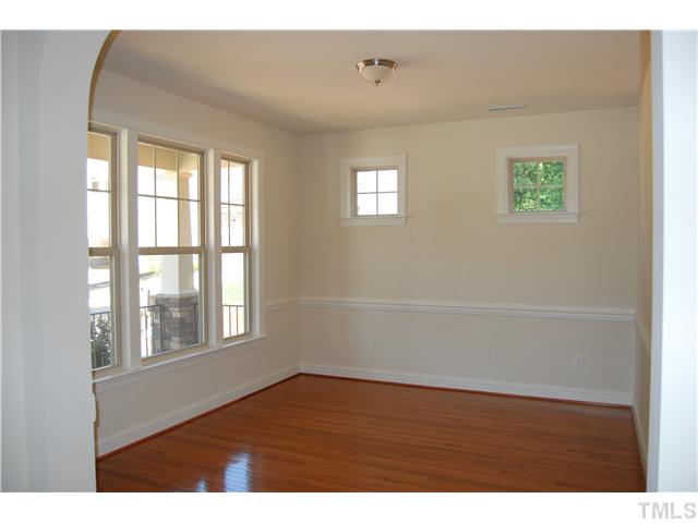 511 Bouree Circle Raleigh, NC 27606 - Photo 9 of 10 a view of an empty room with wooden floor and a window