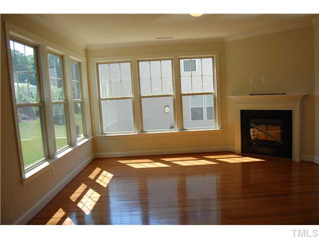 511 Bouree Circle Raleigh, NC 27606 - Photo 10 of 10 a view of an empty room with wooden floor and a fireplace