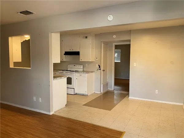 a kitchen with a stove a refrigerator and a sink
