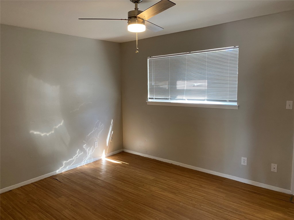 1053 Linde Avenue, Unit 1061 New Braunfels, TX 78130 - Photo 5 of 7 an empty room with wooden floor and windows