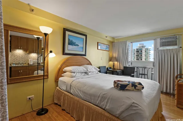 a bedroom with a bed and wooden cabinets