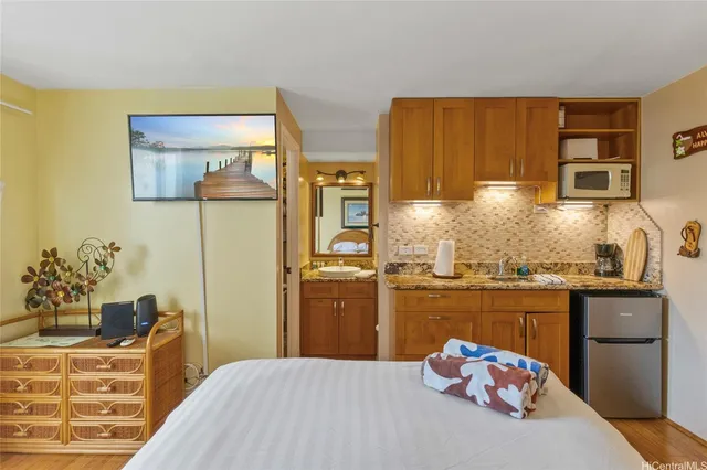 a bedroom with a bed and wooden floor