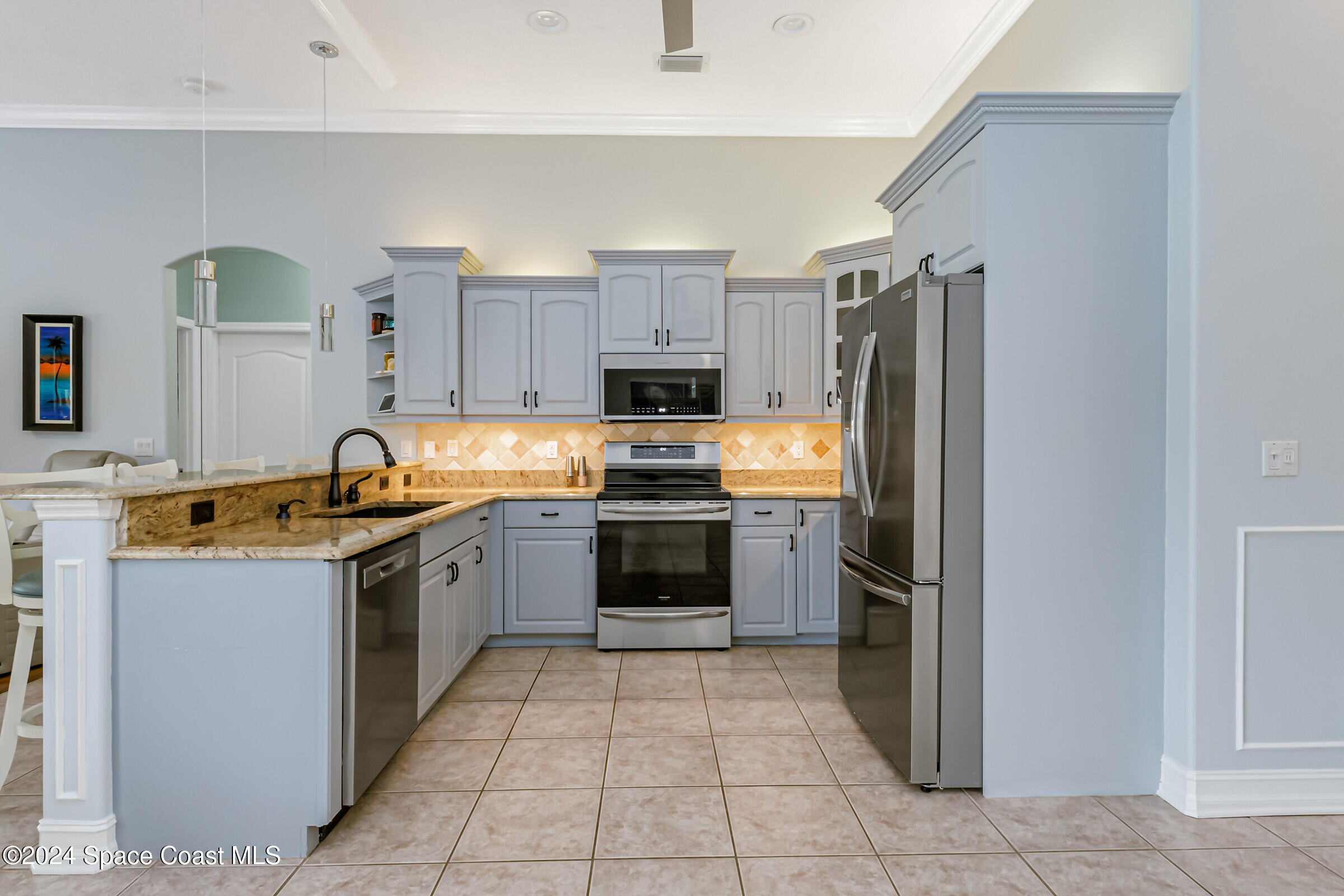 4481 Aberdeen Circle Rockledge, FL 32955 - Photo 11 of 50 a kitchen with granite countertop a refrigerator and a stove