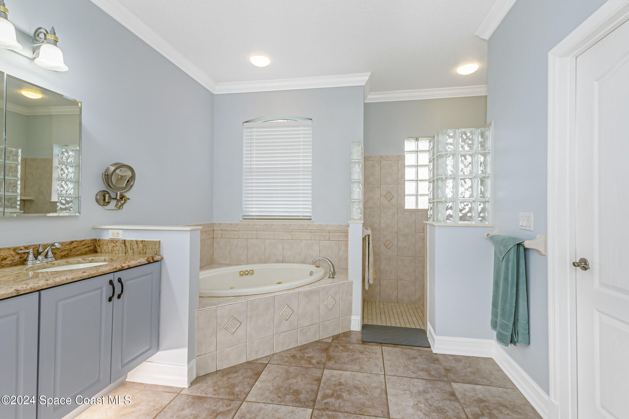 4481 Aberdeen Circle Rockledge, FL 32955 - Photo 18 of 50 a spacious bathroom with a granite countertop sink a toilet and a bathtub