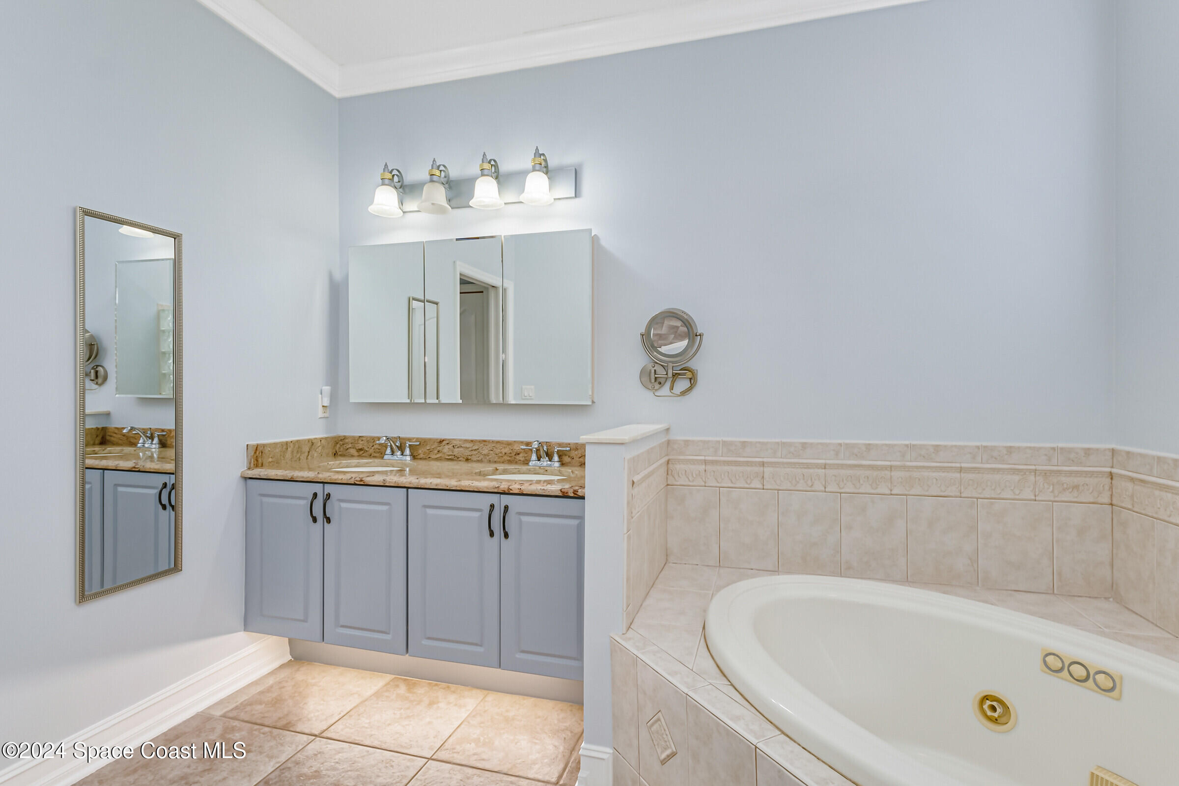 4481 Aberdeen Circle Rockledge, FL 32955 - Photo 19 of 50 a bathroom with a bathtub sink and mirror