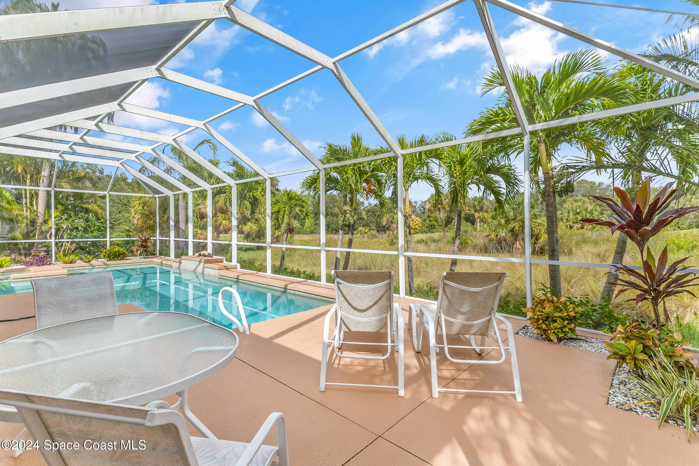 4481 Aberdeen Circle Rockledge, FL 32955 - Photo 31 of 50 a view of a patio with a table and chairs and potted plants