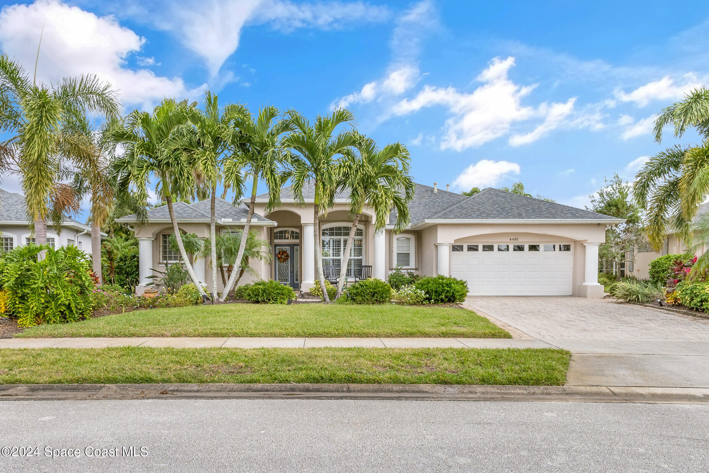 4481 Aberdeen Circle Rockledge, FL 32955 - Photo 39 of 50 a front view of a house with a garden and trees