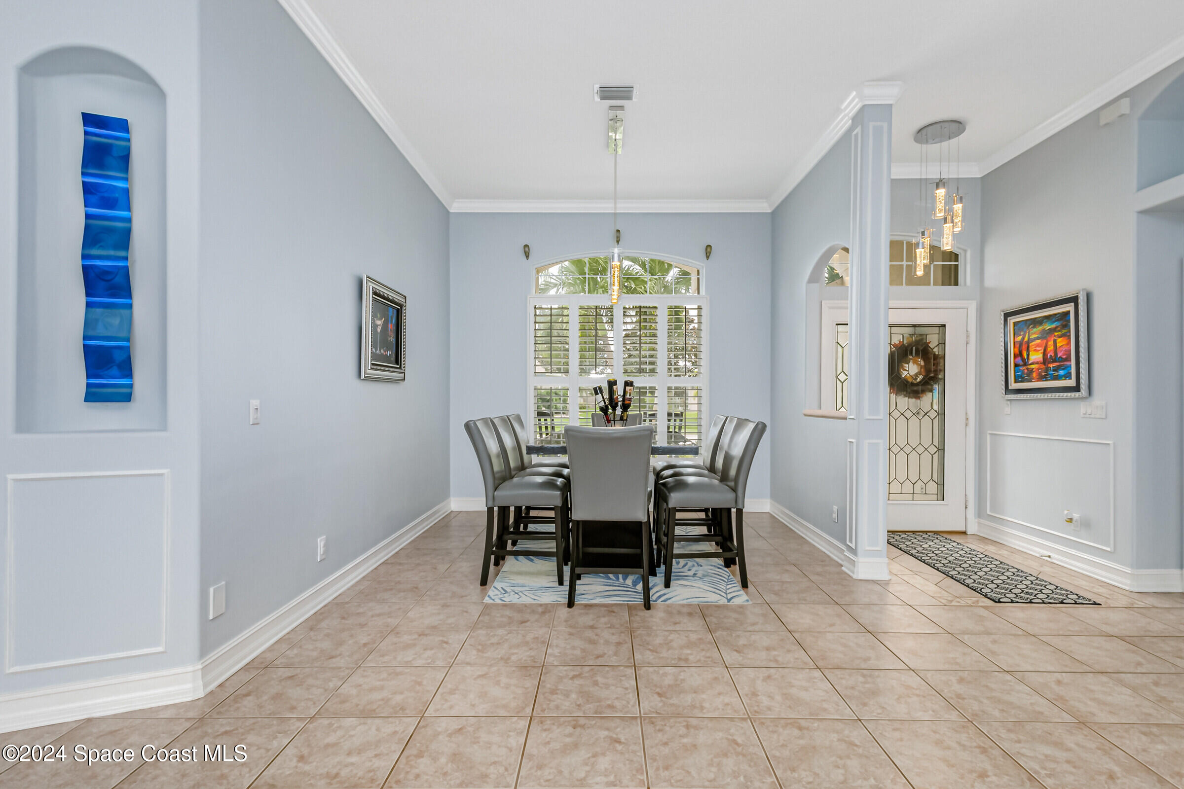 4481 Aberdeen Circle Rockledge, FL 32955 - Photo 6 of 50 a dining room with furniture a chandelier and window