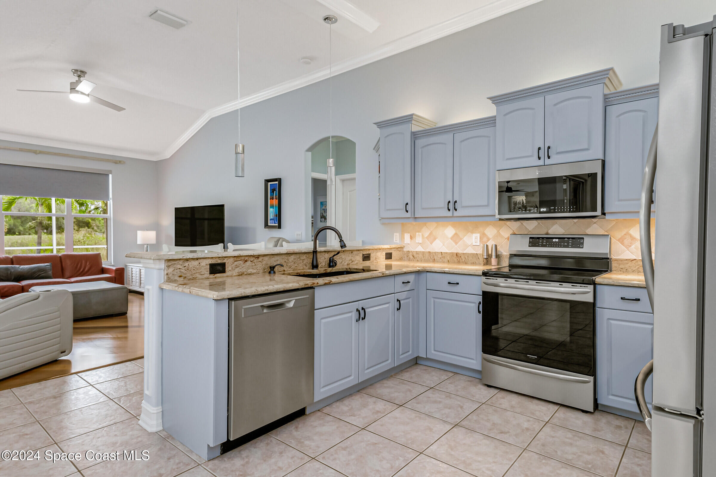 4481 Aberdeen Circle Rockledge, FL 32955 - Photo 10 of 50 a kitchen with stainless steel appliances a stove sink and microwave