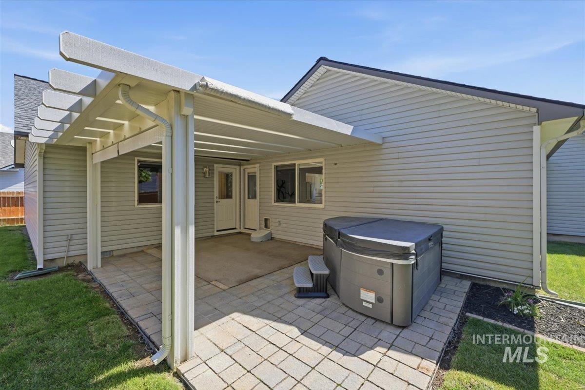2075 North Springland Place Boise, ID 83713 - Photo 42 of 49 Pergola-covered patio featuring paver stones, a built-in spa, and a private yard space