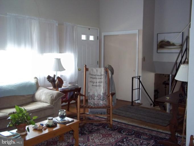 6919 Digby Road Gwynn Oak, MD 21207 - Photo 1 of 24 a living room with furniture and wooden floor