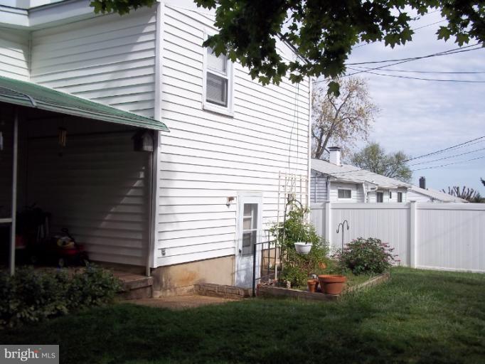 6919 Digby Road Gwynn Oak, MD 21207 - Photo 11 of 24 a view of a house with a yard and plants