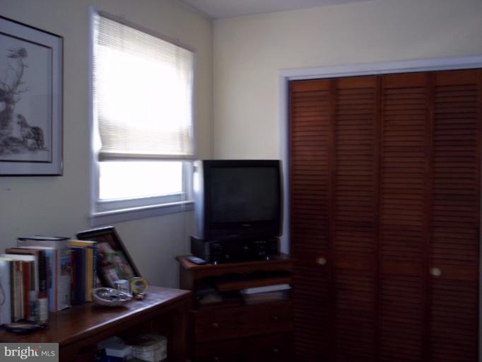 6919 Digby Road Gwynn Oak, MD 21207 - Photo 14 of 24 a living room with a flat screen tv and a window