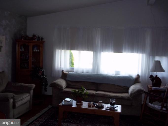 6919 Digby Road Gwynn Oak, MD 21207 - Photo 20 of 24 a living room with furniture lamp and window