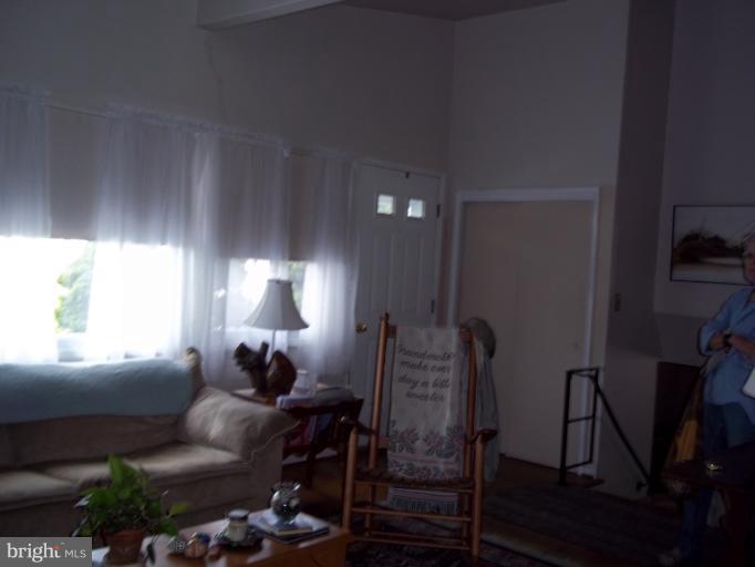 6919 Digby Road Gwynn Oak, MD 21207 - Photo 21 of 24 a living room with furniture a window and a lamp