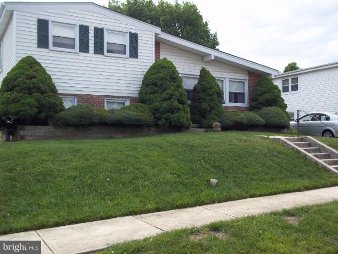 6919 Digby Road Gwynn Oak, MD 21207 - Photo 5 of 24 a front view of a house with a garden