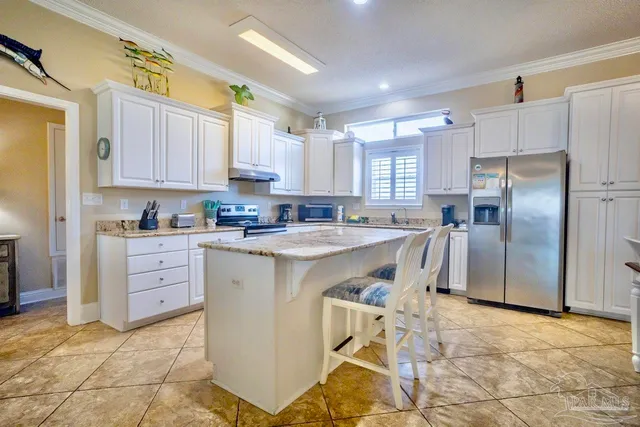 a kitchen with granite countertop a sink a stove and cabinets