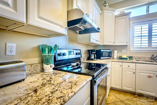 a kitchen with refrigerator and cabinets