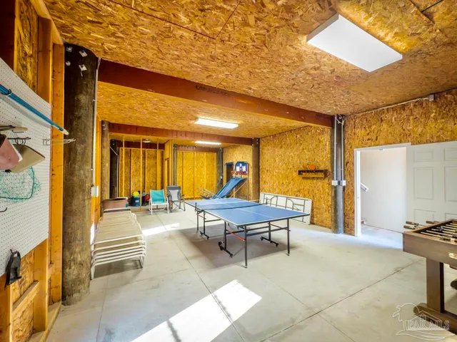 an aerial view of a backyard with table and chairs with wooden fence