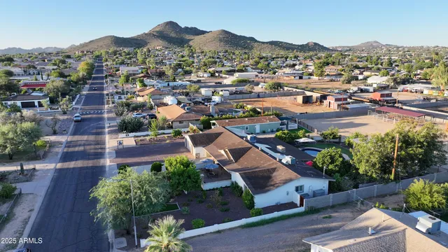 a view of a livingroom with an entryway and kitchen