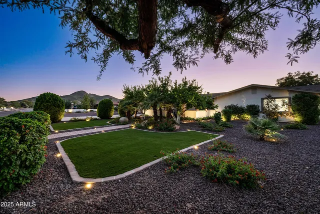 a bathroom with a granite countertop sink a toilet and a mirror