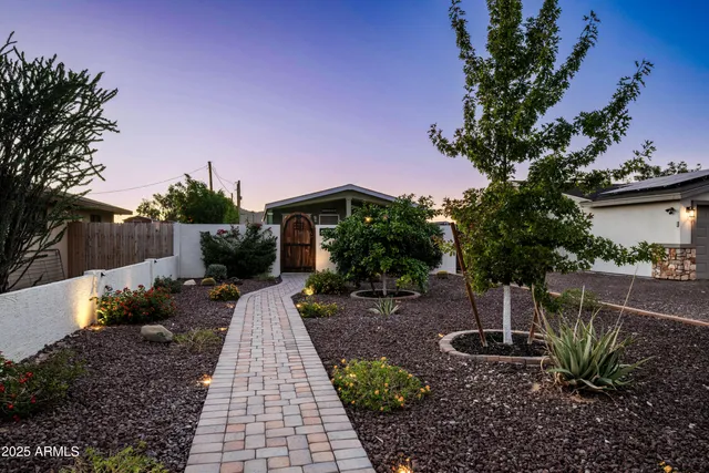a view of a garden with a house in the background