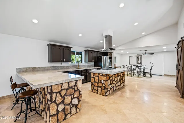 a backyard of a house with table and chairs