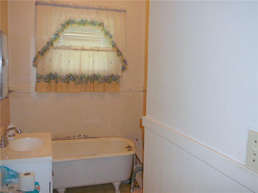 306 B Street Anderson, SC 29625 - Photo 6 of 8 This bathroom features a classic claw-foot tub and a single vanity, creating a charming aesthetic.