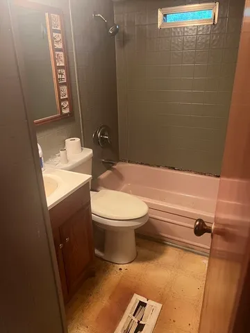 a bathroom with a toilet a sink and bathtub