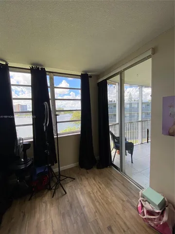 a living room with furniture window and wooden floor