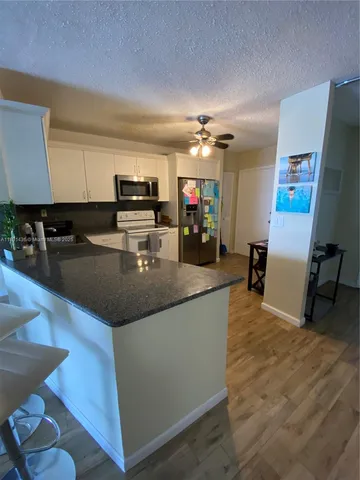 a kitchen with a sink appliances and cabinets