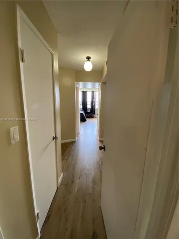 a view of a hallway view with wooden floor and staircase
