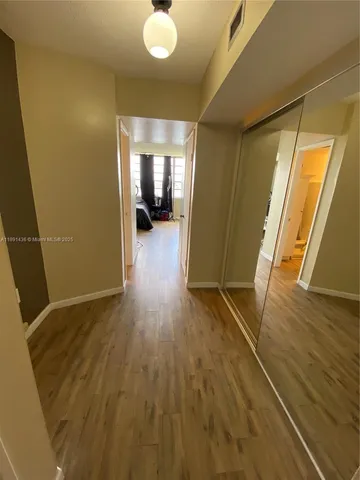 a view of hallway with wooden floor