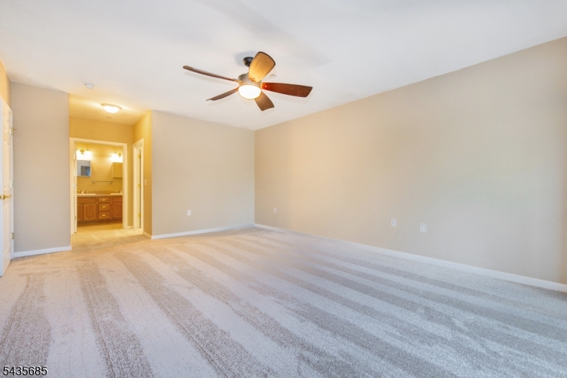 16 Main Street Sparta, NJ 07871 - Photo 23 of 33 an empty room with wooden floor fan and windows